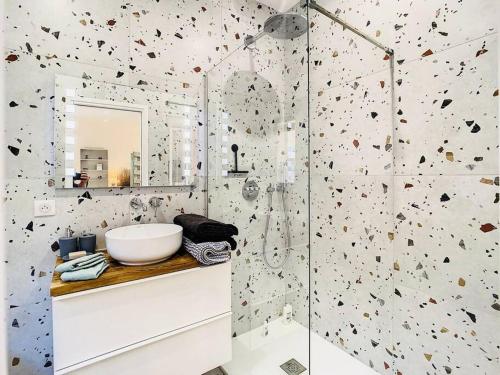 une salle de bain avec un lavabo blanc et un miroir dans l'établissement Appartement Terrasse Proche Port et Plages de Nice, à Nice