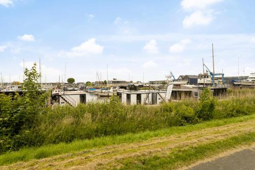 a group of boats parked in a harbor at Cosy tiny houseboats near beach and restaurants by Weltevreden Experience in Zeewolde