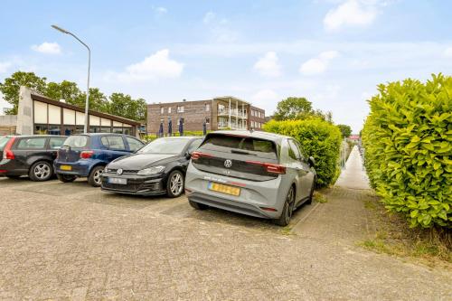 a row of parked cars in a parking lot at Cosy tiny houseboats near beach and restaurants by Weltevreden Experience in Zeewolde