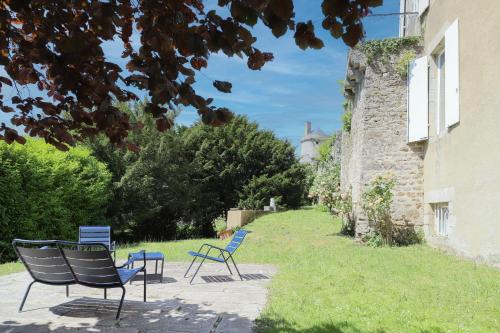 a group of chairs sitting next to a building at Les Deux Marguerite in Alençon