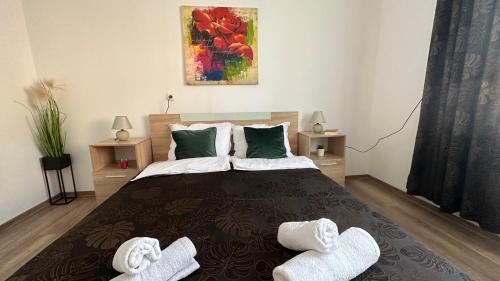 a bedroom with a bed with two slippers on it at Apartment ADELINA in Tsarevo