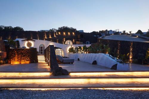 a night view of a house with lights at Theano Cave Suites & Villas in Imerovigli