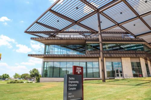 a building with a sign in front of it at Holiday Inn & Suites College Station-Aggieland by IHG in College Station