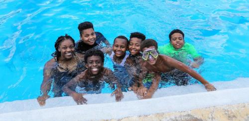 a group of people in a swimming pool at Holiday Inn & Suites College Station-Aggieland by IHG in College Station