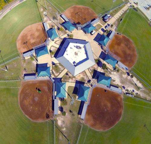 an aerial view of a building in a field at Holiday Inn & Suites College Station-Aggieland by IHG in College Station
