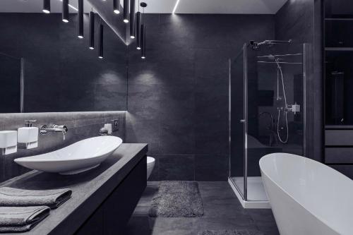 a bathroom with a sink and a toilet and a shower at Odesa Pearl Apartments in Odesa