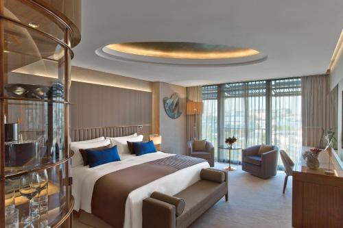 a hotel room with a large bed with blue pillows at The St. Regis Istanbul in Istanbul