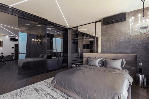 a bedroom with a large bed and a bathroom at Odesa Pearl Apartments in Odesa