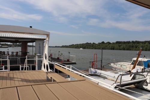 a boat is docked at a dock on the water at Free Room Boat Apartment in Belgrade