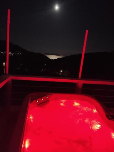 a red tub with lights on a boat at night at STATHIS GUESTHOUSE in Lefkada Town