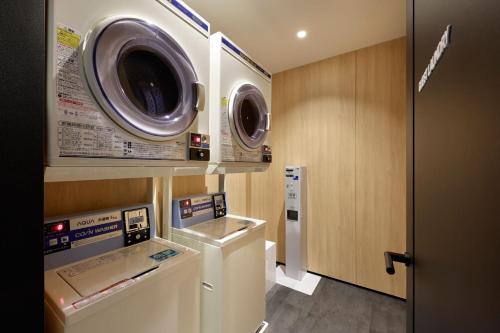 a washing machine and a washer and dryer in a room at Fairfield by Marriott Gifu Gujo in Gujo