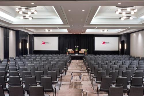 an empty room with chairs and two screens at Austin Marriott South in Austin