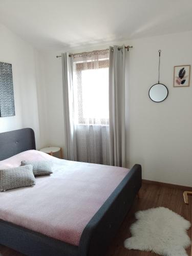 a bedroom with a large bed and a window at MARTINA 2 in Bašanija