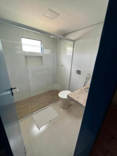 a bathroom with a glass shower and a toilet at Pousada São José in Chapada dos Guimarães