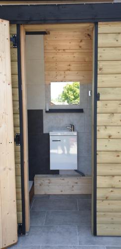 a bathroom with a sink and a window at Aux Passagers de la baie 2 in Le Crotoy