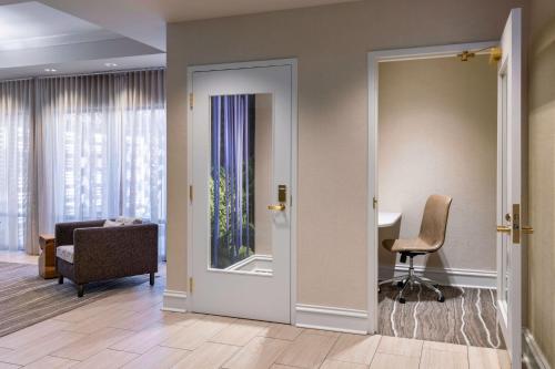 a hallway with a door leading to a room with a table at Sheraton Atlanta Perimeter North in Atlanta