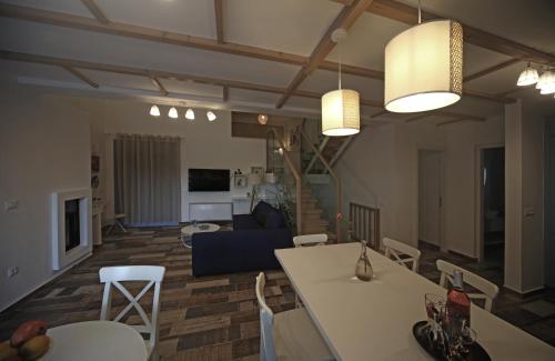 a living room with white tables and chairs and a couch at Ciel Villa in Kalyves