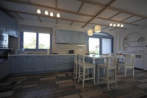 a kitchen with a table and chairs in it at Ciel Villa in Kalyves