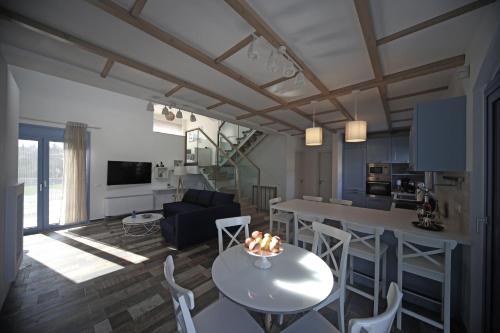 a living room and kitchen with a table and chairs at Ciel Villa in Kalyves