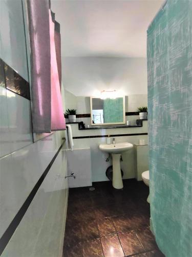 a bathroom with a sink and a toilet at Litus Studios Syros in Megas Yialos-Nites
