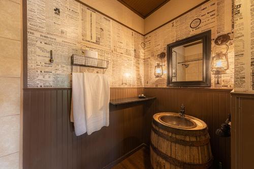 a bathroom with a barrel sink and a mirror at -Pet Friendly- Miners Cabin #6 - King Bed with Private Balcony in Tombstone