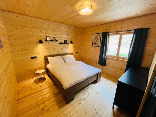 a bedroom with a bed in a wooden room at Holiday House Marin in Selno