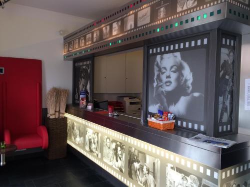 a room with a wall with a picture of a woman at CineHotel Maroni in Zirndorf