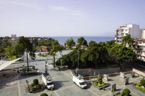 two white vehicles parked in a parking lot near the ocean at Royal Homes 402 in Antalya