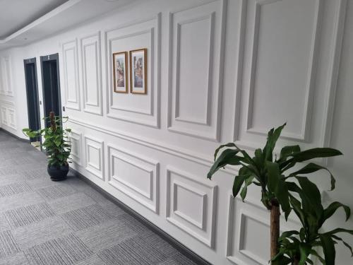 a hallway with white walls and potted plants at Royal Homes 402 in Antalya