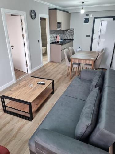 a living room with a couch and a wooden table at Royal Homes 402 in Antalya
