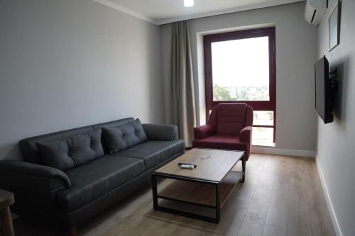 a living room with a couch and a chair and a table at Royal Homes 402 in Antalya