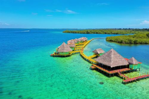 an island with overwater bungalows in the water at Punta Caracol Acqua Lodge in Bocas del Toro