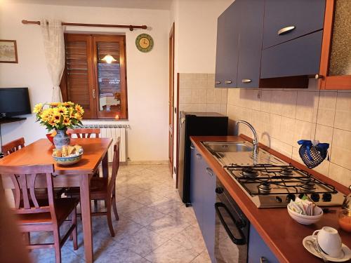 a kitchen with a table and a stove top oven at TERRAZZA GRANDE in Librizzi