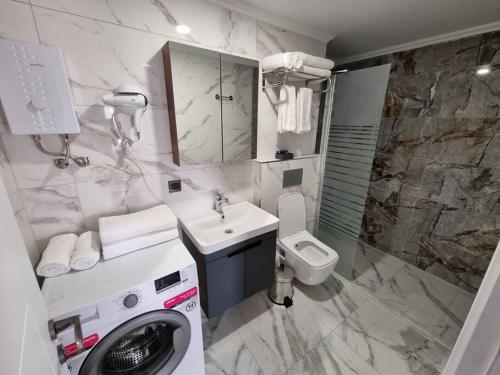 a bathroom with a washing machine and a sink at Royal Homes 403 in Antalya