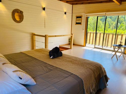 a bedroom with a bed with a backpack on it at Cabaña Auquinco Lago Ranco in Ranco