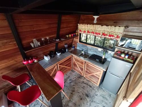 an overhead view of a kitchen in a tiny house at Casa del Árbol (A-Frame) - Ágape del Bosque in Monteverde Costa Rica