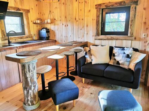 a living room with a couch and a table at La Cabane d'Ode in Sainte-Ode