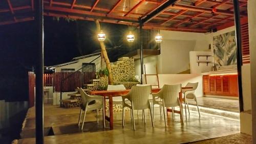 a dining area with a table and chairs at Las Terrazas de Barili Private Resort in Barili