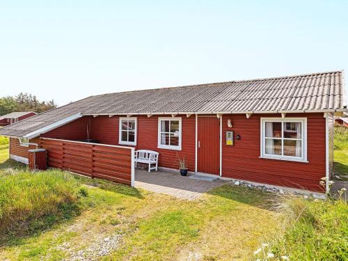a red house with a patio in front of it at Family-friendly Retreat near Beach - By Traum Ferienwohnungen in Lild Strand
