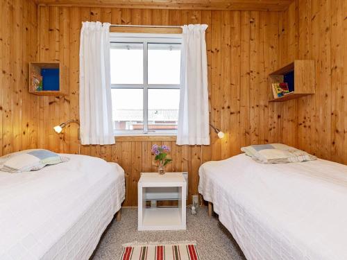 Duas camas num quarto com uma janela em Three-Bedroom Holiday home in Frøstrup 1 em Lild Strand