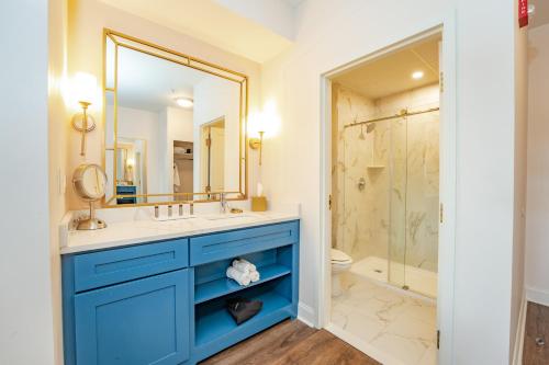 a bathroom with a blue vanity and a shower at Chateau Renault in Egg Harbor City