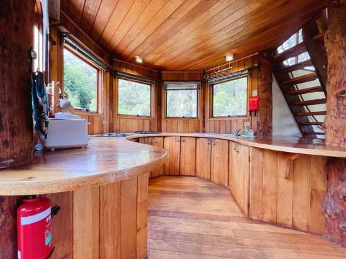 a large room with wooden walls and a large wooden table at The 'Nook' - Cabin in the Tassie Wilderness! in Ridgeway