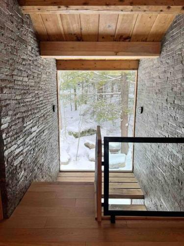 a room with a staircase and a large window at WoodHunterHome in Platte Clove