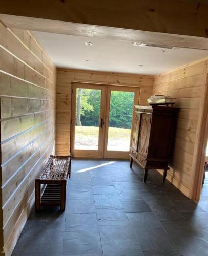 an empty room with a bench and a door at WoodHunterHome in Platte Clove