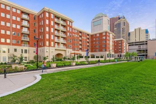 a park in front of a building with tall buildings at The KING Apt in Downtown Columbus in Columbus