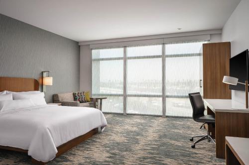 a hotel room with a bed and a desk at Element Anaheim Resort Convention Center in Anaheim