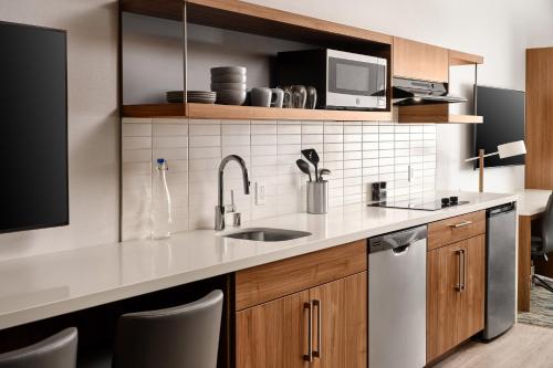 a kitchen with a sink and a microwave at Element Anaheim Resort Convention Center in Anaheim
