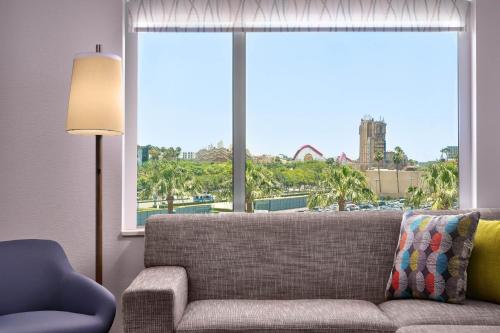 a living room with a couch and a large window at Element Anaheim Resort Convention Center in Anaheim