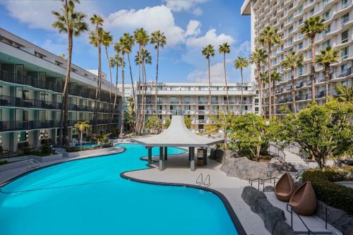 an image of a resort pool with palm trees at Los Angeles Airport Marriott in Los Angeles