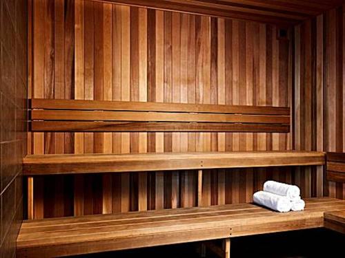 a sauna with two towels sitting on a wooden bench at City View Luxury 3 Bedroom Apartment-Free Car Park in Melbourne